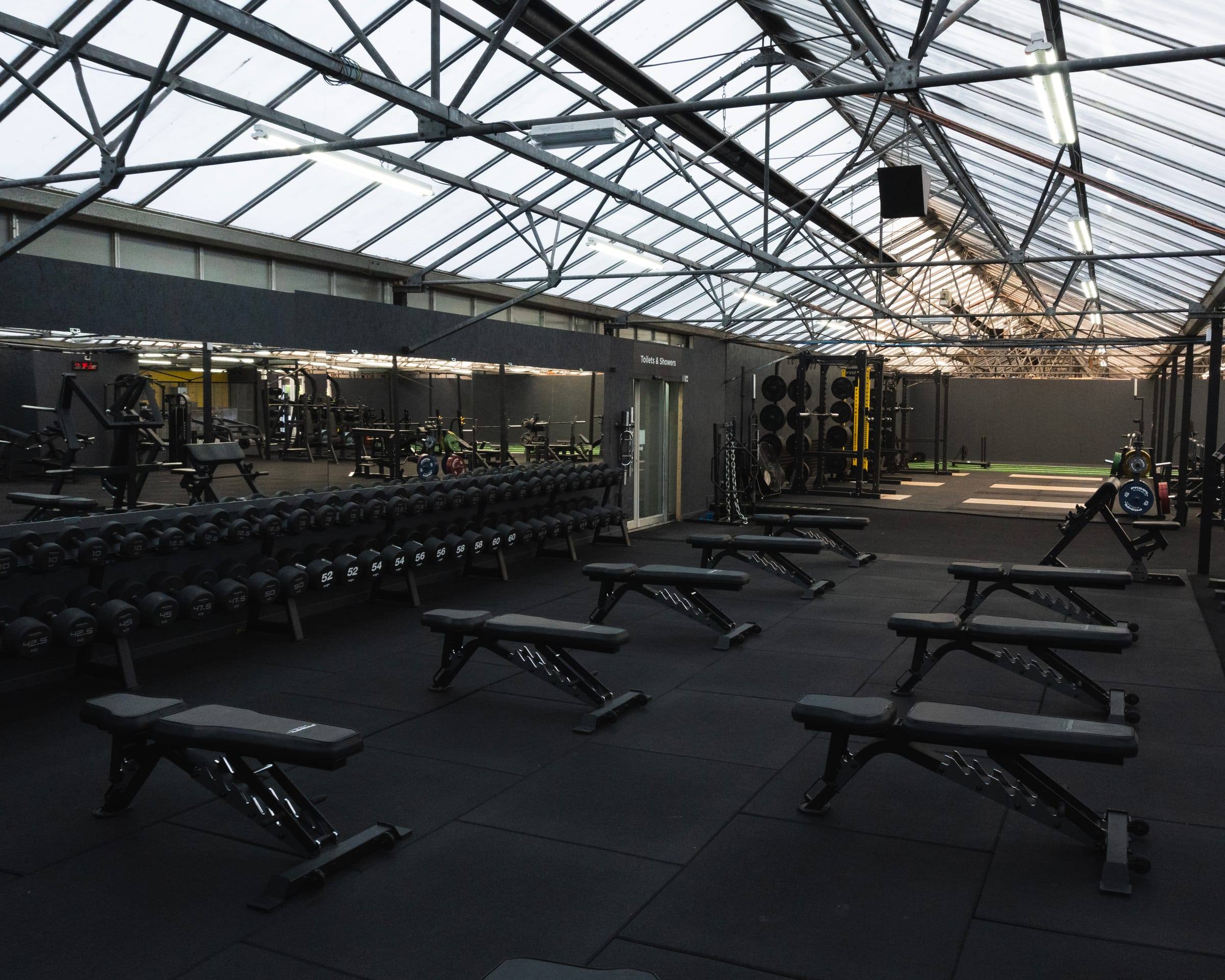 Mirrored dumbbell wall and benches at Base Gym Bristol