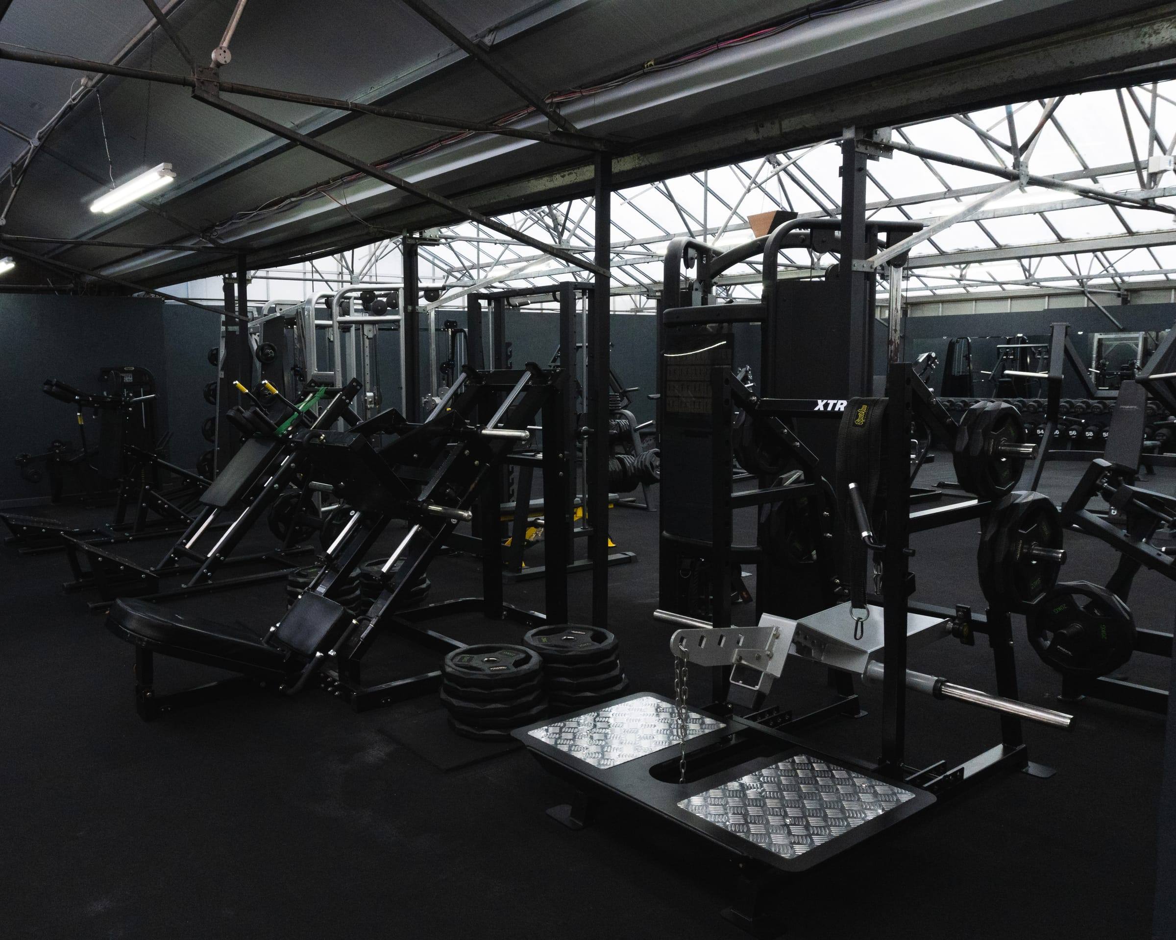 Plate-loaded leg machines on the Bristol gym floor
