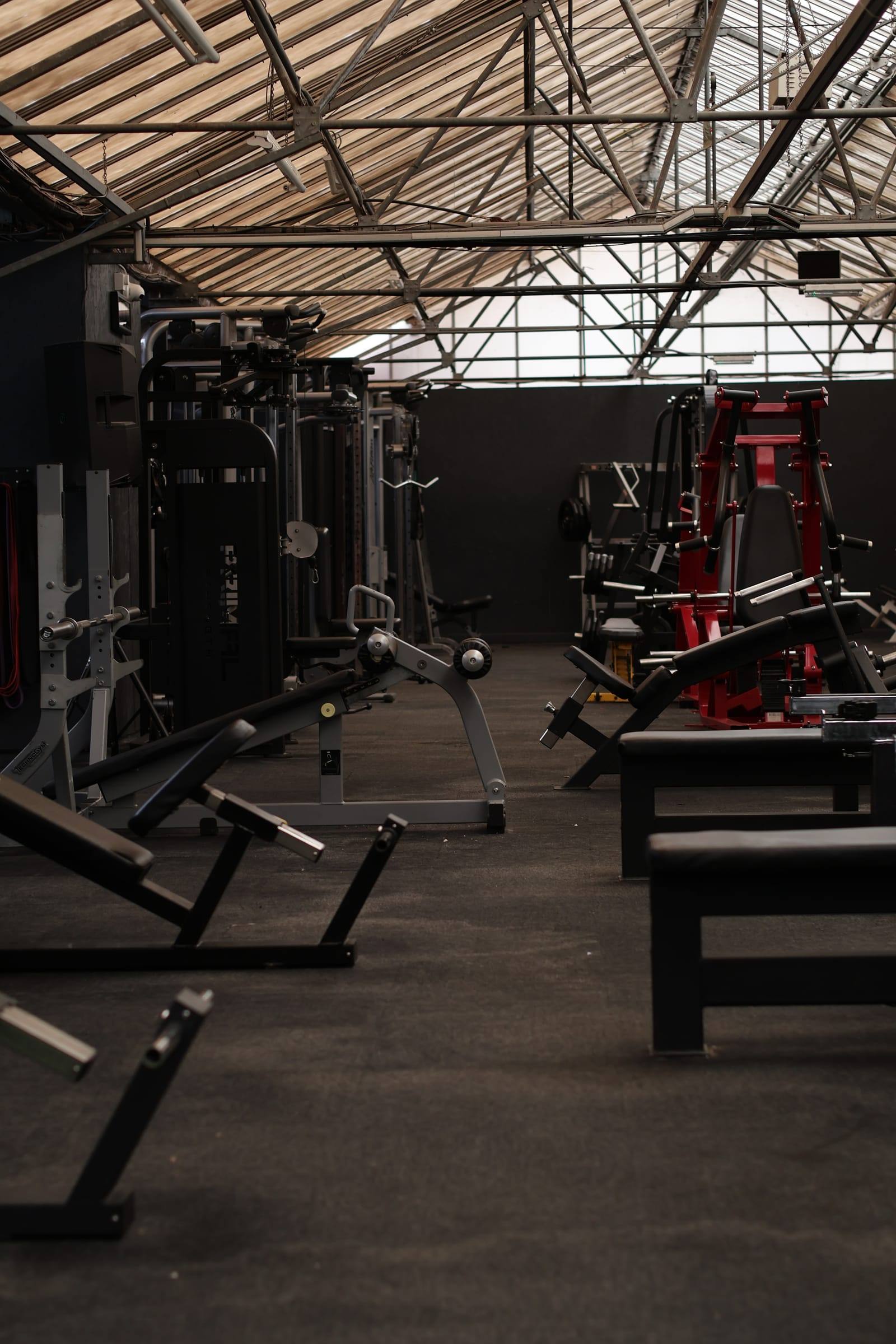 Aisle of machines and benches leading to a red plate-loaded machine at Bristol